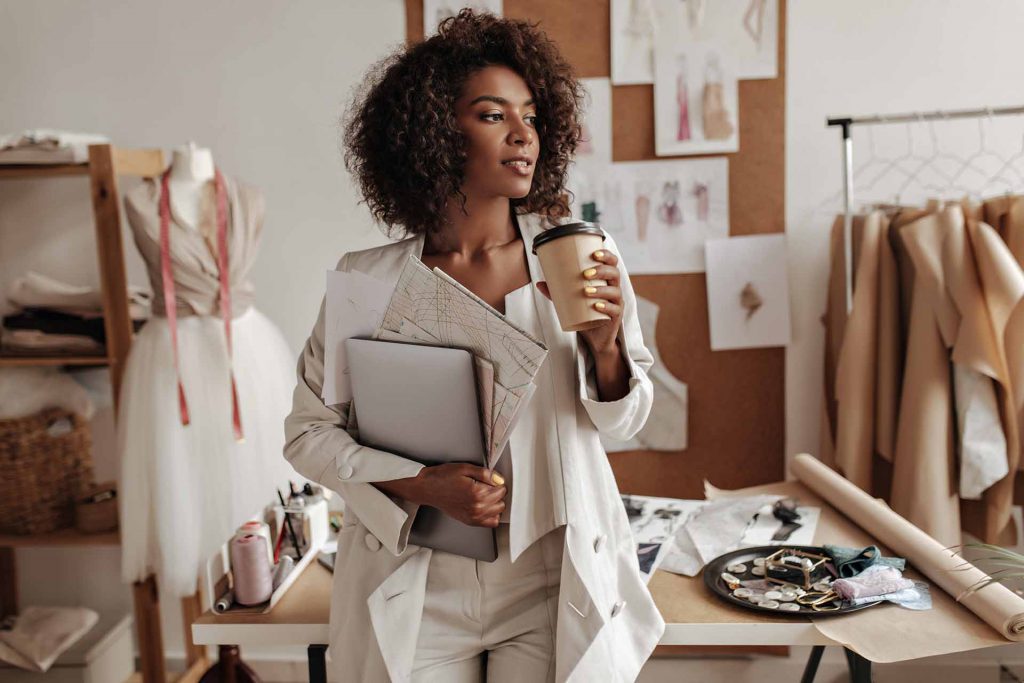LuAru Studio blog post image curly fashion woman holding a coffee cup and laptop