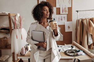 LuAru Studio blog post image curly fashion woman holding a coffee cup and laptop