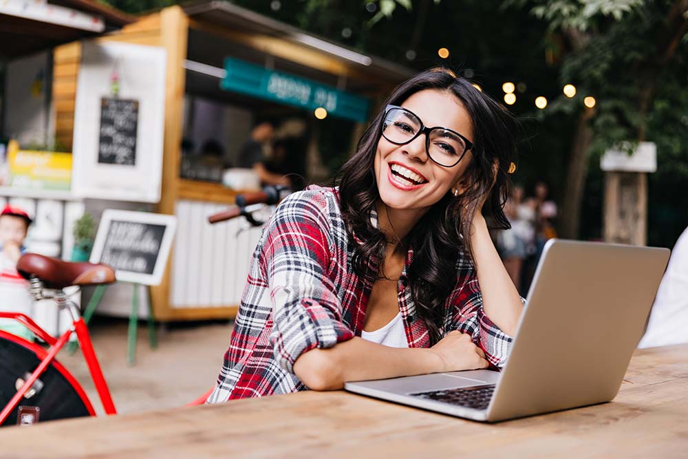 LuAru Studio blog archive image woman smiling next to laptop